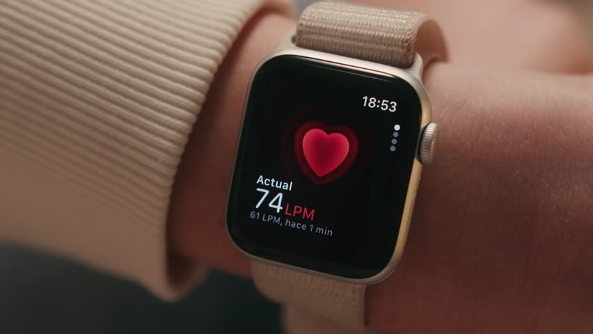 A close-up of a wrist as she measures her pulse and heart rate using a smartwatch, capturing a moment of personal health monitoring. High quality 4k footage