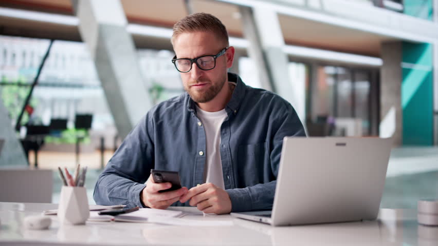 Man Carefully Scans Payroll Cheques To Ensure Accurate Salary Compensation.