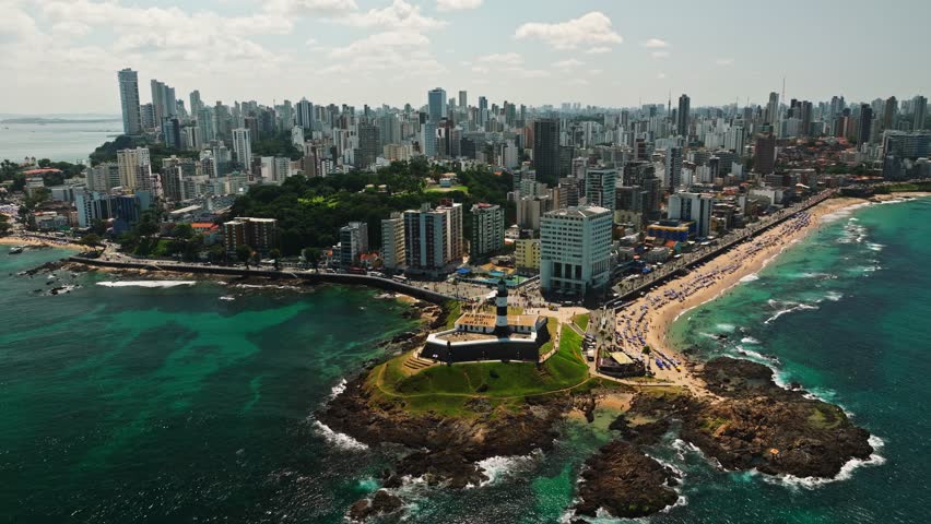 Aerial view of Salvador da Bahia cityscape, Barra Lighthouse, beach and azure sea. Tropical Travel Destination. Aerial landscape of Coastal City. Salvador, Bahia, Brazil.
