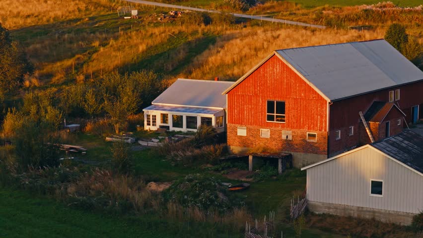 Aerial View Of A Wooden Barn House And Glasshouse In Rural Landscape.