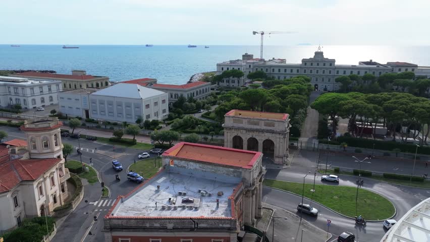 expansion of the naval academy overlooking coastal Livorno Italy with shipping traffic at sea in the background, busy shipping hub entrance nearby