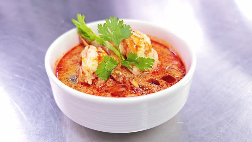 Spicy and sour Thai shrimp soup with coconut milk and chili paste, traditional Asian food.