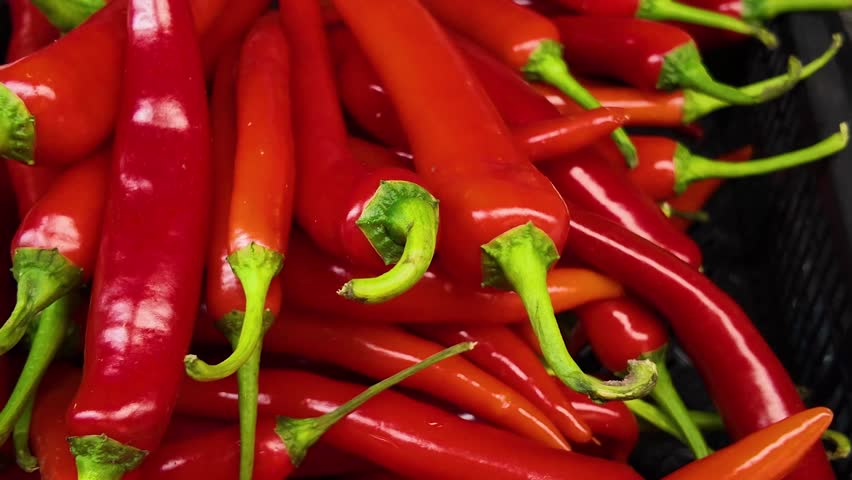 Ripe fresh red cayenne peppers in supermarket, natural background