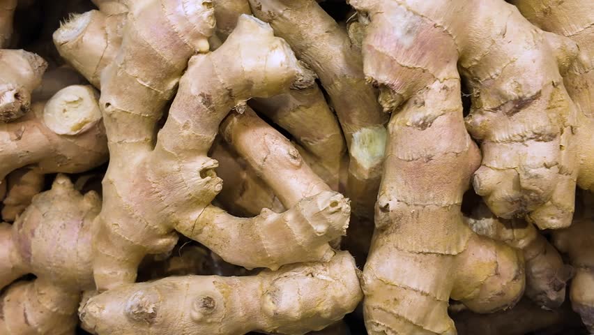 Fresh ripe raw ginger roots in a box in a supermarket, natural background