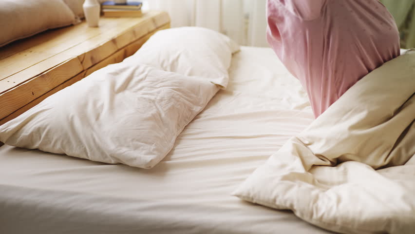 Happy senior woman lying in comfortable bed and smiling, morning routine