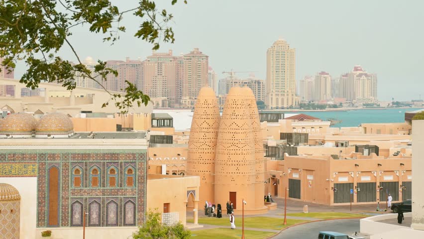 Doha, Qatar - january 7th, 2026: timelapse zoom in Katara Cultural Village in Doha, Qatar. People enjoy the promenade by the iconic Pigeon Towers and Blue Mosque, blending heritage modern city views