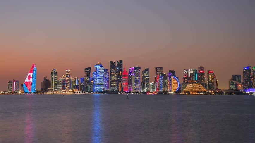Doha, Qatar - january 8th, 2026: day to night timelapse Doha skyline at night from the Corniche. Iconic illuminated skyscrapers business district luxury middle east gulf colorful night architecture