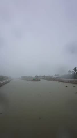 Misty River Scene with Buildings