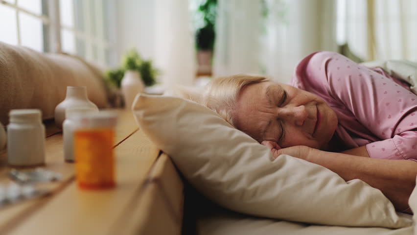 Senior woman sleeping in bed after taking antidepressants, healthy rest