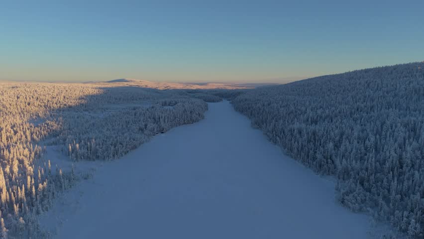 Glide over the stunning landscapes of Akaslompolo, where tranquil lakes meet endless forests blanketed in snow. Experience the magical light of a winter day in Akaslompolo, Lapland