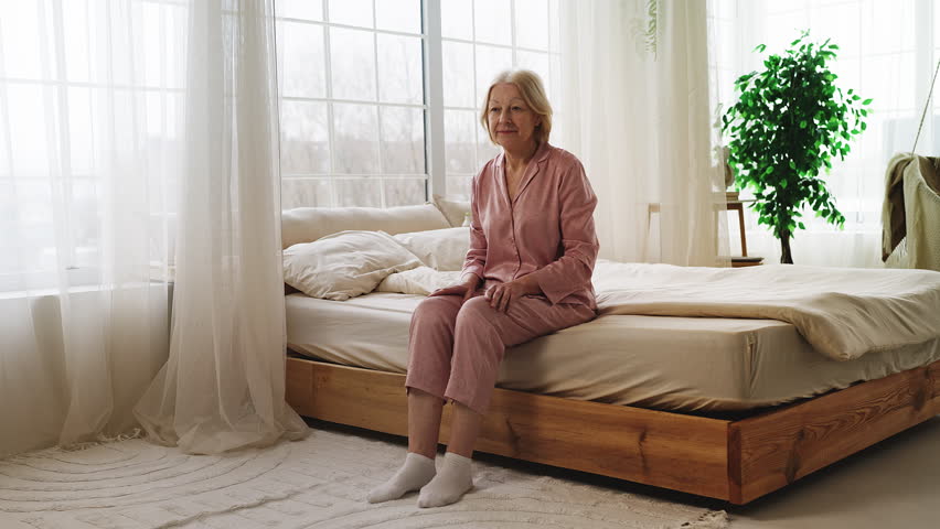 Senior woman massaging swollen painful legs, suffering varicose veins