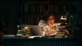 Concentrated African American student researching in library during late night - Powered by Shutterstock - Get 15% off with code: PIKWIZARD15
