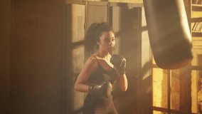 Motivated Black woman boxing with punching bag in gym, active sports hobby - Powered by Shutterstock - Get 15% off with code: PIKWIZARD15