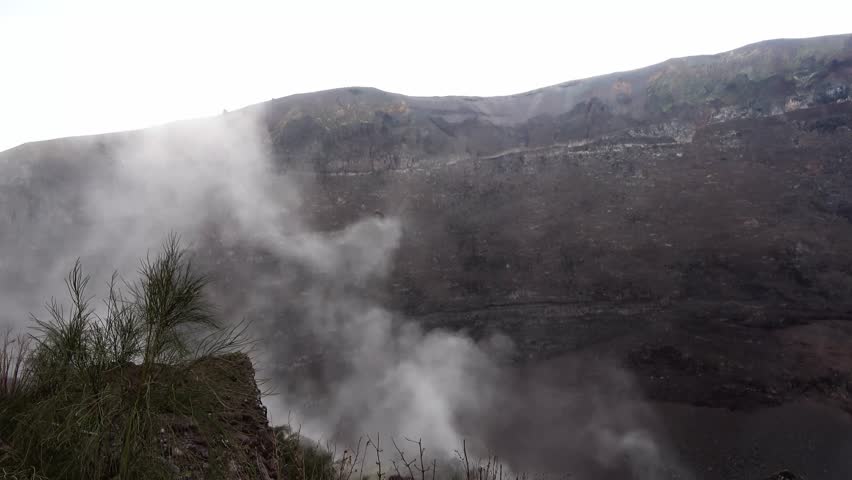 White fumarolic gas rising from the crater of the famous Vesuvius volcano near Naples, Italy