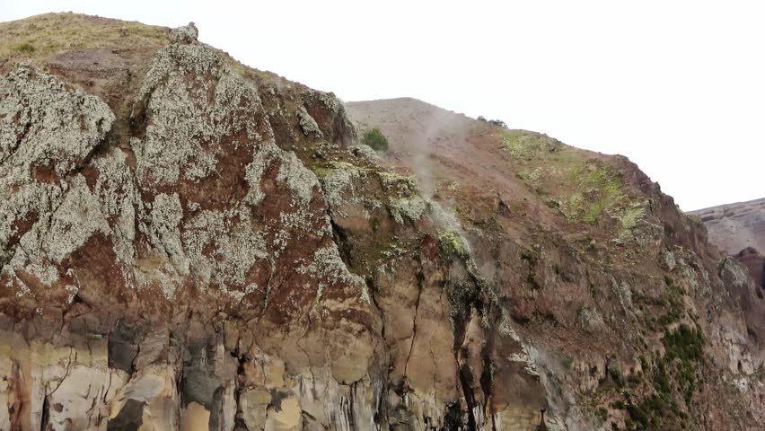 Volcanic steam rising from the rocky caldera of the active Mount Vesuvius volcano near Naples