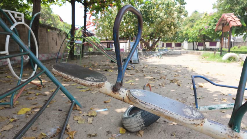 Old Playground with Iron Swings and Merry-Go-Rounds
