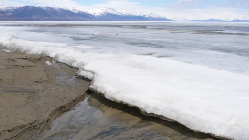 The icy shore of Lake Baikal in Russian Siberia in late spring. The northernmost point of Lake Baikal is located in the small town of Nizhneangarsk.
