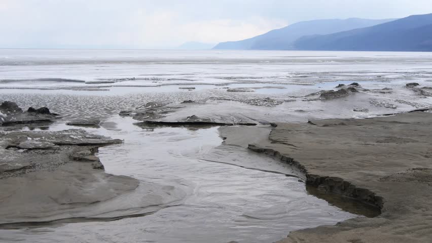 The icy shore of Lake Baikal in Russian Siberia in late spring. The northernmost point of Lake Baikal is located in the small town of Nizhneangarsk.

