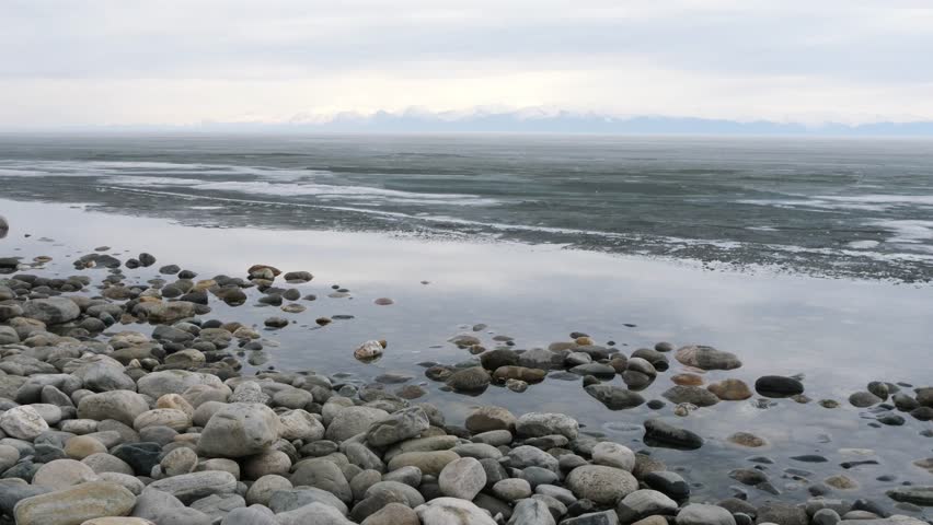The icy shore of Lake Baikal in Russian Siberia in late spring. The northernmost point of Lake Baikal is located in the small town of Nizhneangarsk.
