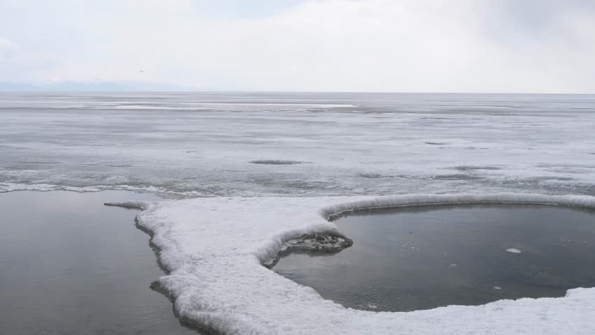 The icy shore of Lake Baikal in Russian Siberia in late spring. The northernmost point of Lake Baikal is located in the small town of Nizhneangarsk.
