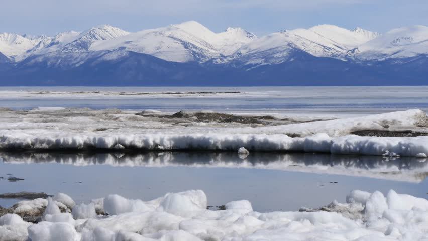 The icy shore of Lake Baikal in Russian Siberia in late spring. The northernmost point of Lake Baikal is located in the small town of Nizhneangarsk.

