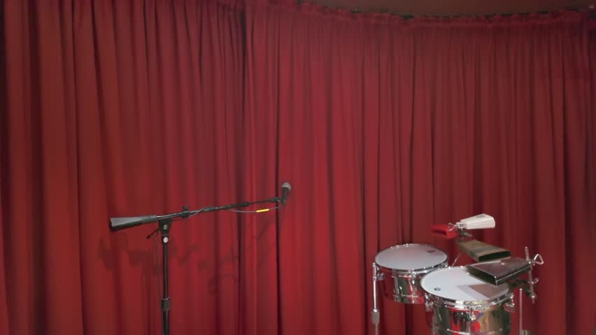 Professional black drum kit stage setup with miced kick drum