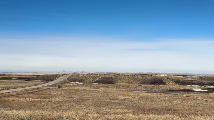 Rural prairie farm fields in Alberta Canada under open sky, showcasing agriculture, farmland, and natural landscape.