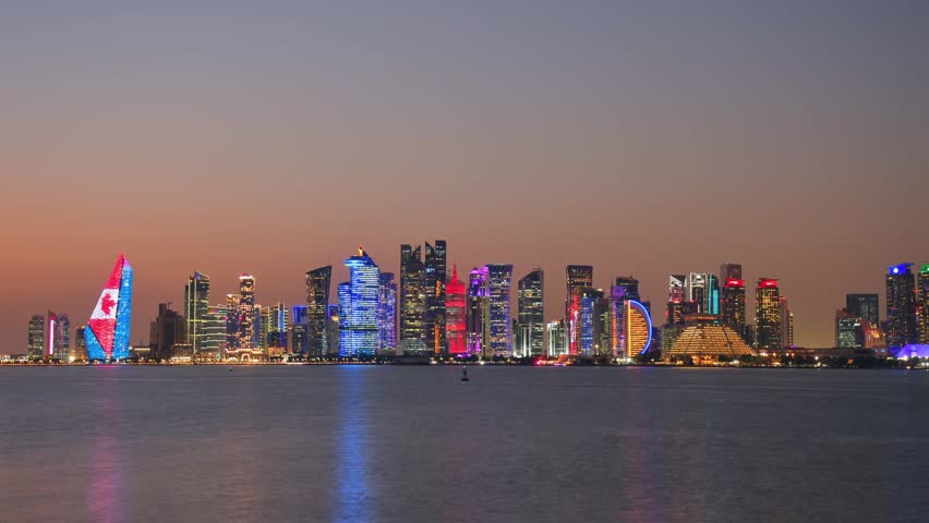 Doha, Qatar - january 8th, 2026: day to night timelapse Doha skyline at night from the Corniche. Iconic illuminated skyscrapers business district luxury middle east gulf colorful night architecture