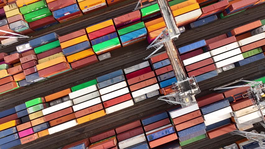 Drone shot of modern industrial container port of Rotterdam with containers from top view. It is an import and export cargo port where is a part of shipping dock. 4K