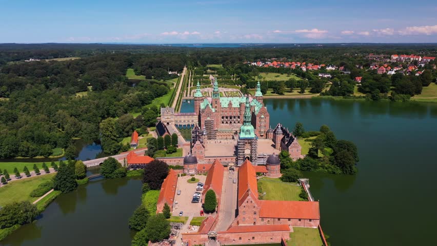 Aerial view of Frederiksborg castle in Hillerod Denmark during sunny summer day with majestic architecture and lake