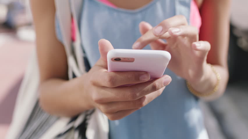 Hands, phone and scroll with texting in city with travel, bag and booking taxi on web for commute. Person, smartphone and click on mobile app, notification or social media with tourism in urban town