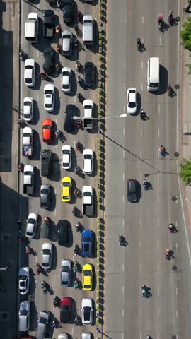 Aerial view of massive traffic jam in Bangkok, Thailand. Packed lanes of cars, buses, and motorbikes showing daily rush hour and urban life in Asia.