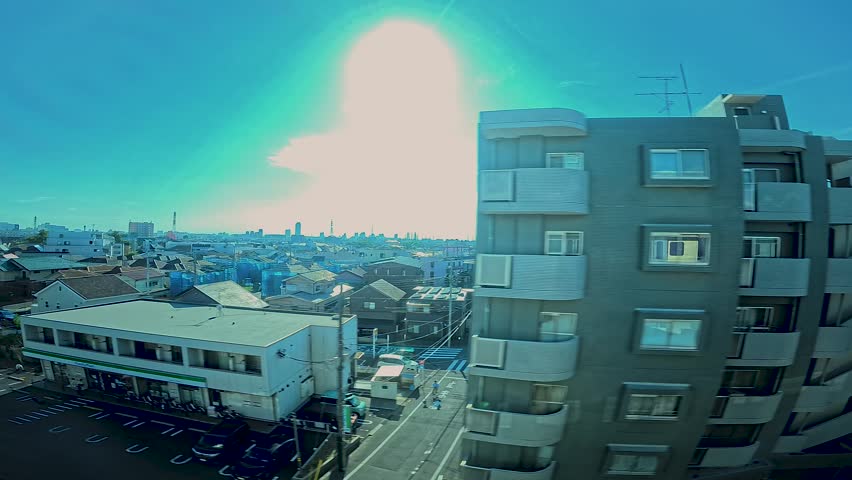 A cityscape by side view of a moving urban monorail at the downtown in Tokyo