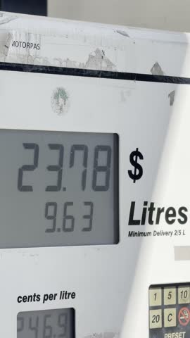 Close up of petrol pump screen showing rising cost and litres during refueling. Concept highlights fuel price increase, inflation, and cost of living.