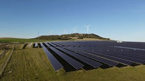 Drone Flying Over Solar Panels with Wind Turbines on Hill – Hybrid Renewable Energy Infrastructure - Powered by Shutterstock - Get 15% off with code: PIKWIZARD15