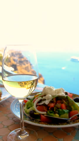 Greek salad and wine in Greece in a restaurant. Selective focus.