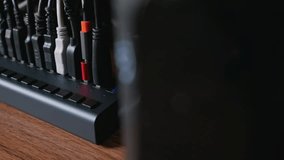 A close-up view of a powered USB hub with multiple cables connected, sitting on a wooden desk. Concept of connectivity, data transfer, cable management, and a modern digital workspace. - Powered by Shutterstock - Get 15% off with code: PIKWIZARD15