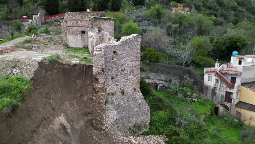 A landslide and collapse, an environmental disaster and destruction. The historic fortress wall collapsed during heavy and prolonged rains. Rocks, mud, and debris completely buried parked cars.