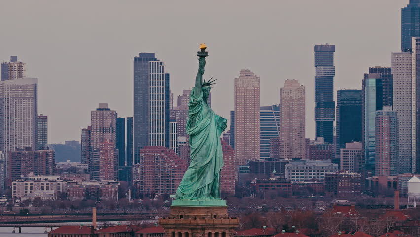 Aerial panorama of New York City with Liberty statue. Drone view of Liberty statue above New York City. Liberty statue in New York City from above. Aerial view with Liberty statue and NYC.