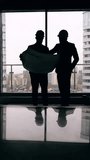 Construction business professionals reviewing blueprint in modern office. Engineers planning development project and discussing investment details. Concept of business agreement, partnership, growth - Powered by Shutterstock - Get 15% off with code: PIKWIZARD15