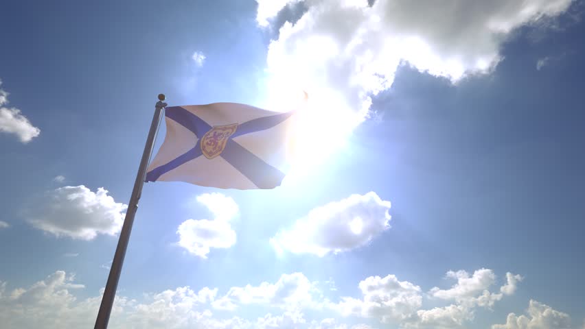 Nova Scotia Flag (Canada) waving on a Flagpole from a Moving Angle in front of a blue sky with clouds