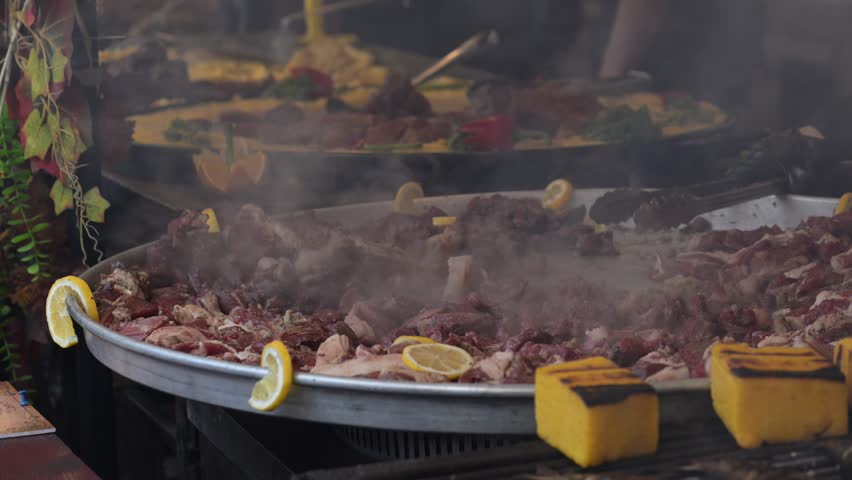 Large cooking pot with meat and vegetables at a market in Romania during the day