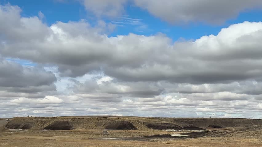Rural prairie farm fields in Alberta Canada under open sky, showcasing agriculture, farmland, and natural landscape.