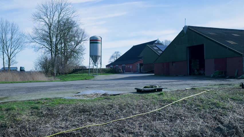 Rural farm buildings and a silo in the countryside