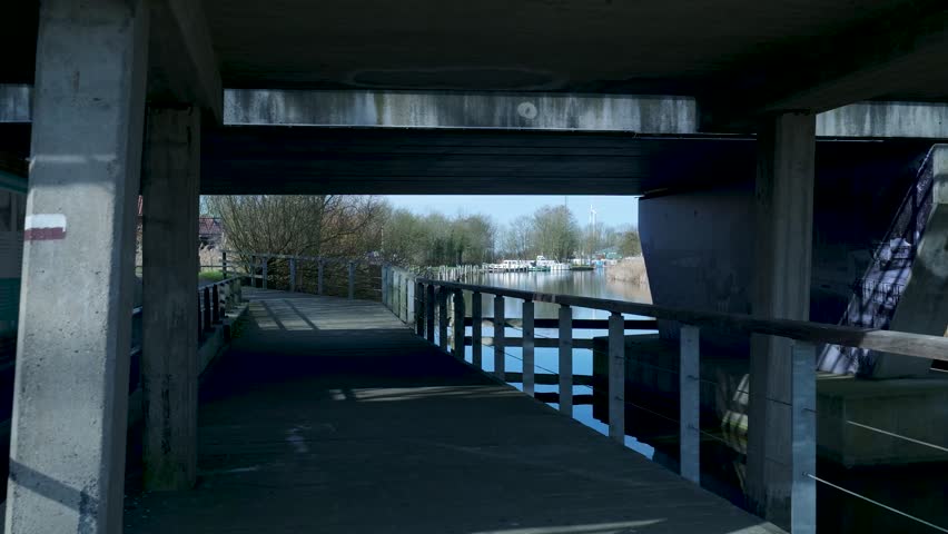 Walking on a wooden boardwalk along a quiet dutch canal