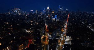 Well-illuminated streets of New York at night time. Drone flight over the dazzling panorama of Big Apple. - Powered by Shutterstock - Get 15% off with code: PIKWIZARD15