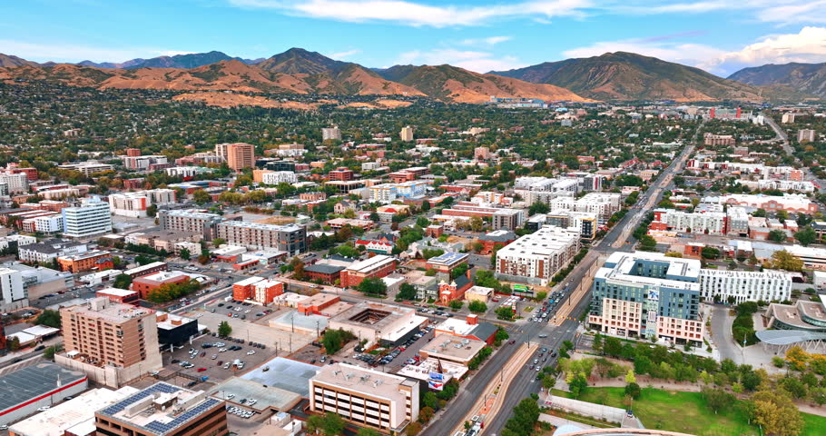 Footage above the urban landscape of modern Salt Lake City, Utah, USA. Approaching the rocks with scarce vegetation around the city.
