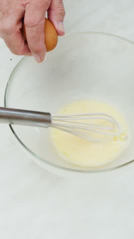 Preparing beaten eggs for an Italian omelette homemade food