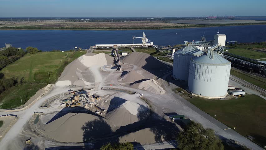 Port corridor near Virginia Ave, Cooper River and North Charleston Terminal active bulk transfer infrastructure. Industrial aggregate, metal silos, long conveyors coastal material operations, SC. USA