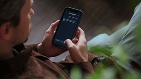 Close up of a man holding a smartphone, using an AI chatbot app for work, brainstorm a business project. Personal Artificial intelligence assistant helping with productivity. Space for text - Powered by Shutterstock - Get 15% off with code: PIKWIZARD15